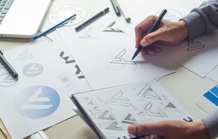 Logo designer designing a logo on paper