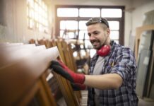 What To Look For In Quality Furniture Carpenter checking quality of his work in carpentry workshop.