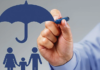 The Ultimate Guide to Buying Term Insurance: What You Need to Know Hand Holding Pen