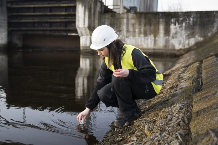Full-Shot-Environmental-Engineer-Getting-Water-Sample