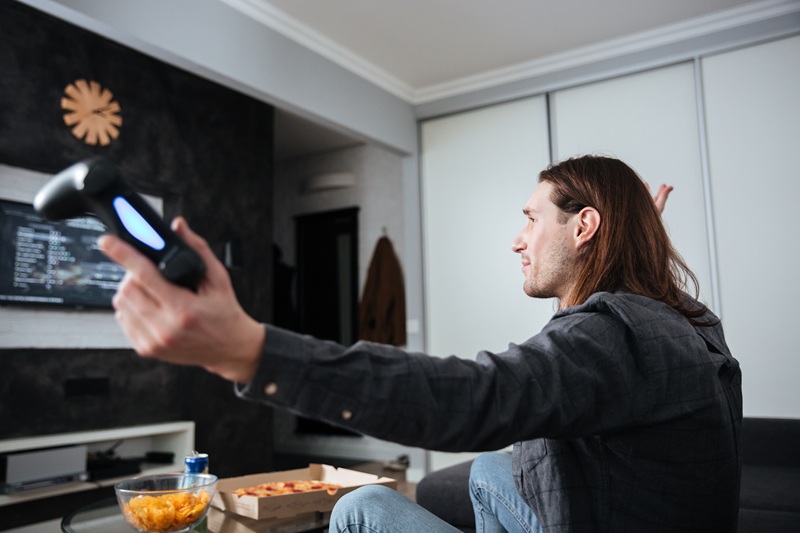 Reliable Home Fixtures that Don’t Need Tech to Survive Side view image of young sad man gamer sitting at home